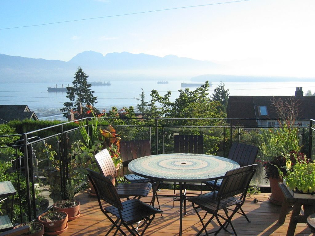 Furnished patio with a mosaic table, city view, and lush greenery. - 4663 Bellevue Drive, Vancouver West Side