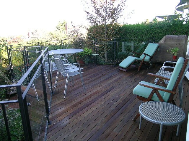 Furnished patio with wooden deck, outdoor seating, and greenery. - 4663 Bellevue Drive, Vancouver West Side