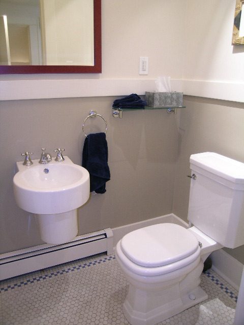 Bathroom with white sink, toilet, and hexagonal tile floor. - 4663 Bellevue Drive, Vancouver West Side