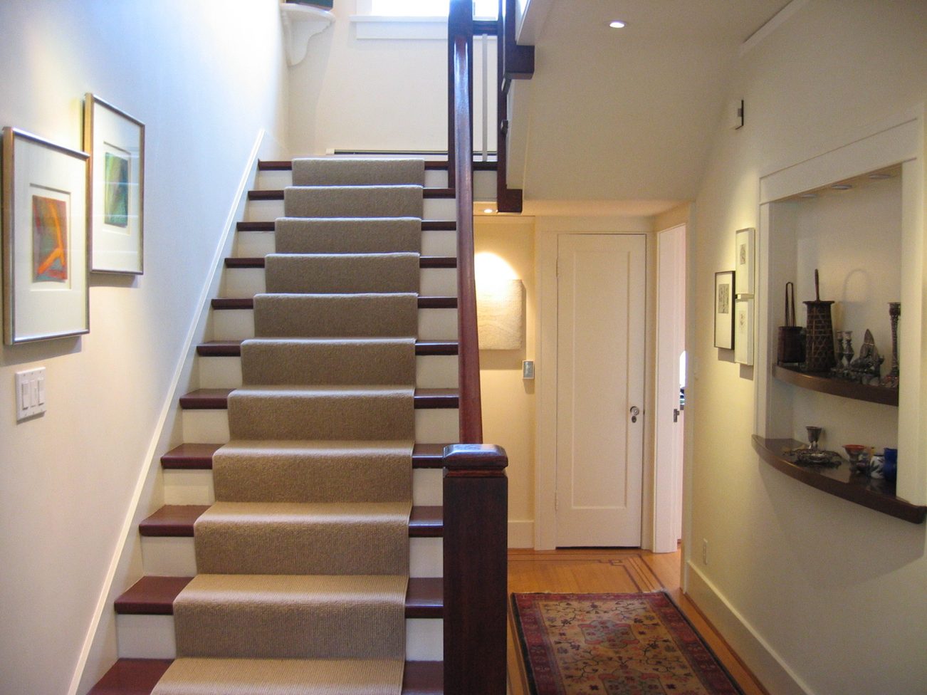 Staircase leading to upper floor with carpeted steps and wooden handrail. - 4663 Bellevue Drive, Vancouver West Side