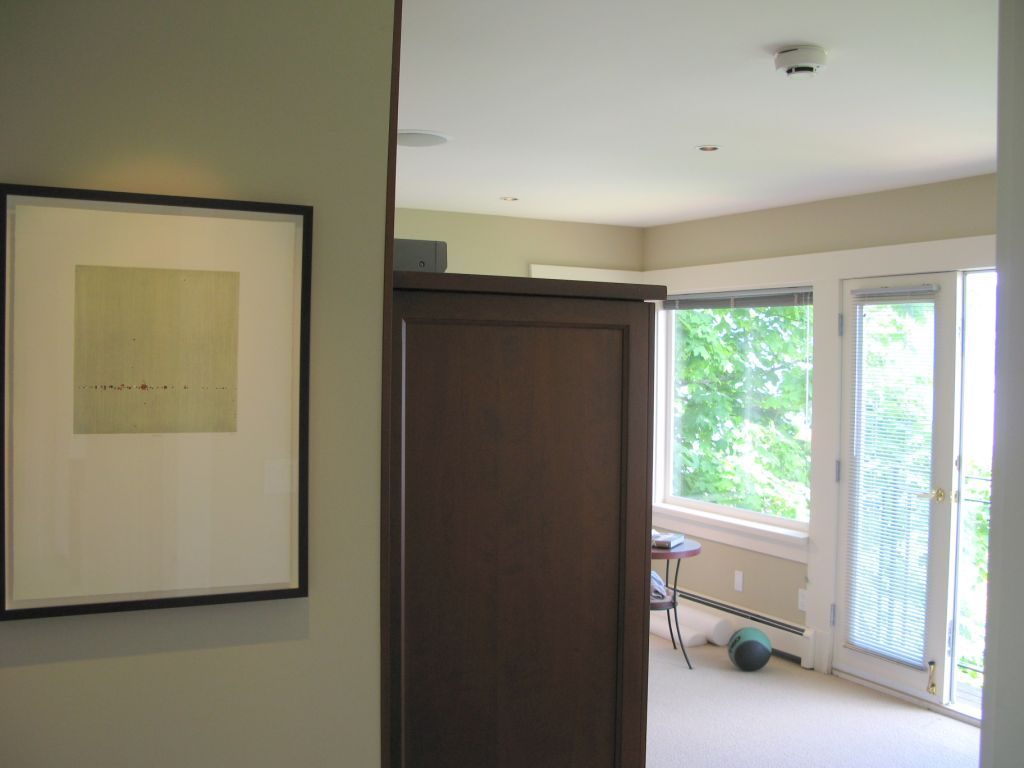 Bright living room with large windows, exercise ball, and abstract art. - 4663 Bellevue Drive, Vancouver West Side
