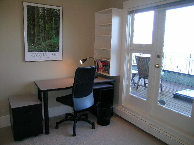 Small office with desk, chair, bookshelf, and forest poster. - 4663 Bellevue Drive, Vancouver West Side