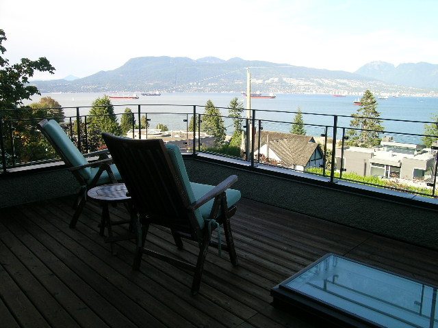 Furnished living room with a stunning city view and wooden deck. - 4663 Bellevue Drive, Vancouver West Side