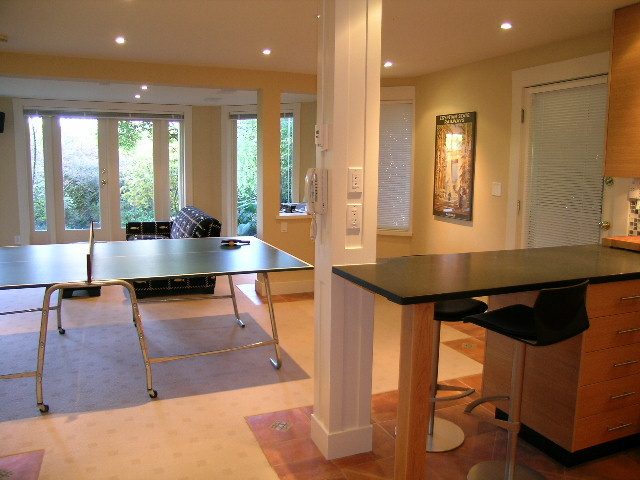 Bright kitchen with hardwood floors and a city view, featuring a large island and modern cabinetry. - 4663 Bellevue Drive, Vancouver West Side