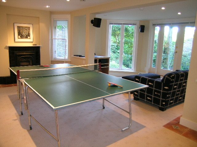 Living room with large windows, ping pong table, and comfortable seating. - 4663 Bellevue Drive, Vancouver West Side
