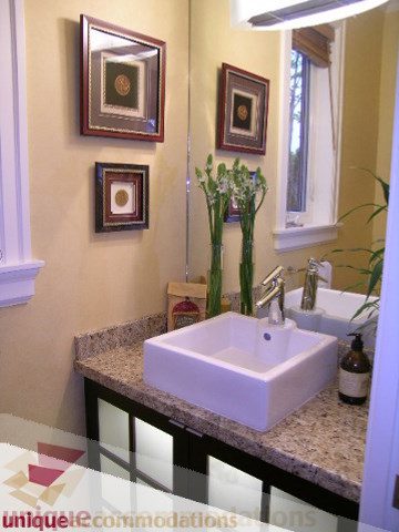 Bathroom with granite countertop and modern sink, framed artwork on wall. - 3030 West 15th Avenue, Vancouver West Side