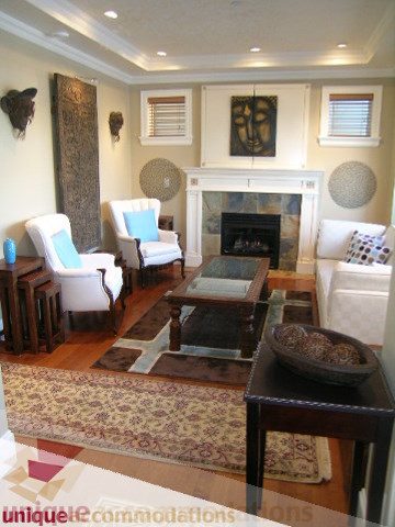 Furnished living room with hardwood floors, fireplace, and patterned rug. - 3030 West 15th Avenue, Vancouver West Side