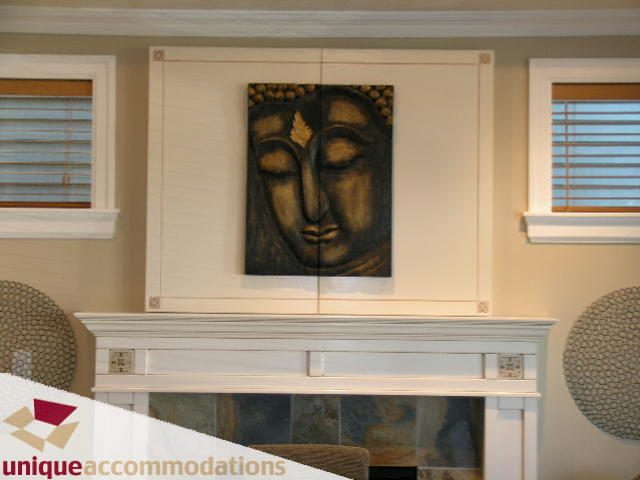 Furnished living room with a modern fireplace and decorative wall art. - 3030 West 15th Avenue, Vancouver West Side