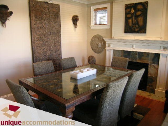 Dining area with glass table, textured chairs, and decorative wall art. - 3030 West 15th Avenue, Vancouver West Side