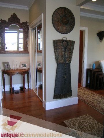 Furnished hallway with hardwood floors and decorative wall art. - 3030 West 15th Avenue, Vancouver West Side