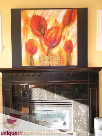 Living room with fireplace and vibrant tulip painting above. - 3030 West 15th Avenue, Vancouver West Side