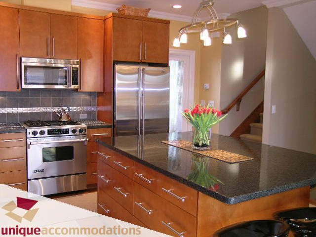 Bright kitchen with granite countertops and stainless steel appliances, modern design. - 3030 West 15th Avenue, Vancouver West Side