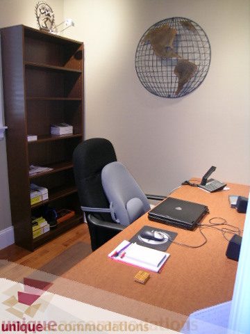 Furnished office space with a desk, globe, and bookshelf. - 3030 West 15th Avenue, Vancouver West Side