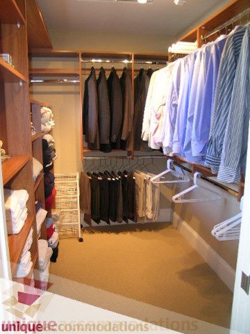 Walk-in closet with neatly organized shirts and hanging space, light-colored carpeting. - 3030 West 15th Avenue, Vancouver West Side