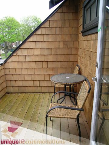Furnished balcony with wicker chairs and wooden flooring. - 3030 West 15th Avenue, Vancouver West Side