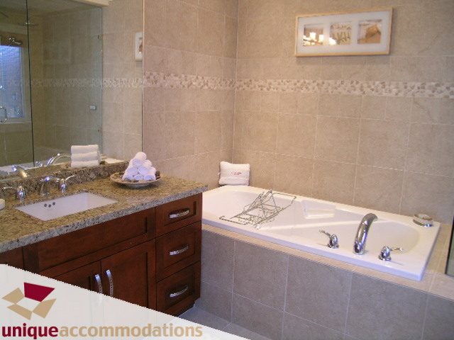 Spacious bathroom with granite countertops and modern fixtures. - 3030 West 15th Avenue, Vancouver West Side