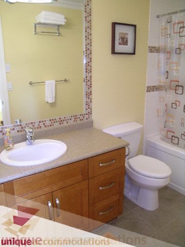 Bathroom with granite countertops and wooden cabinets. - 3030 West 15th Avenue, Vancouver West Side