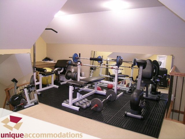 Bright home gym with weightlifting equipment and exercise mats. - 3030 West 15th Avenue, Vancouver West Side