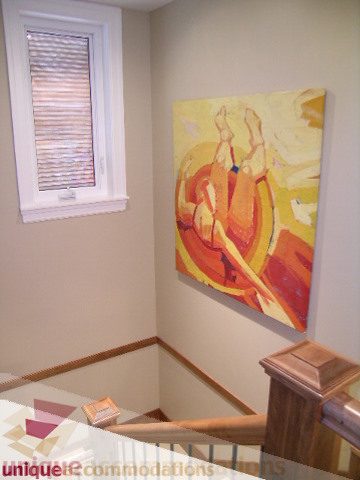Bright hallway with colorful artwork and wooden banister. - 3030 West 15th Avenue, Vancouver West Side