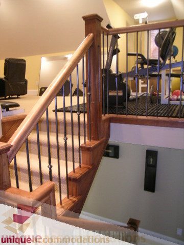 Staircase with wooden banister and black metal spindles leading to upper level. - 3030 West 15th Avenue, Vancouver West Side