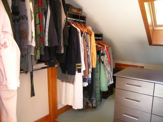 Bright walk-in closet with neatly organized clothes and hanging racks. - 2148 Kings Ave, West Vancouver