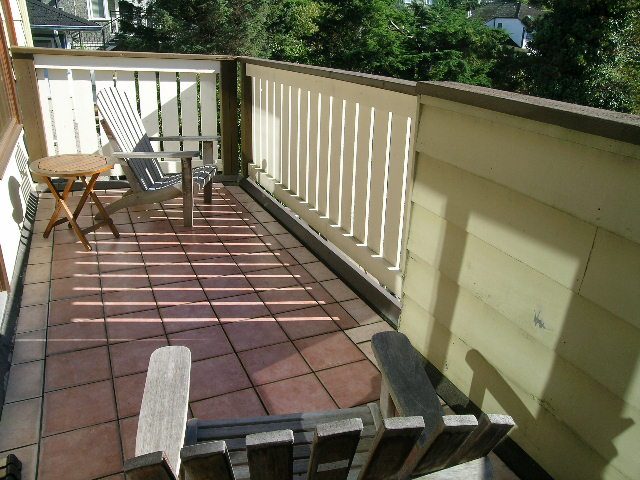 Spacious balcony with tiled flooring, wooden railings, and outdoor furniture. - 2148 Kings Ave, West Vancouver