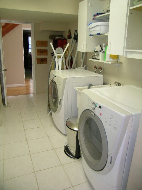 Bright laundry room with white appliances and tiled floor. - 2148 Kings Ave, West Vancouver