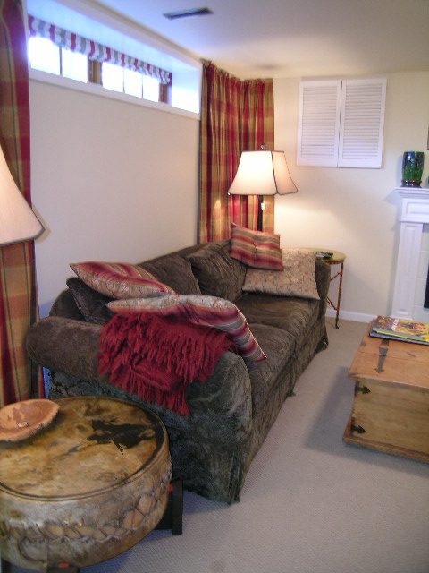 Cozy living room with rustic furniture, plaid curtains, and a fireplace. - 2148 Kings Ave, West Vancouver