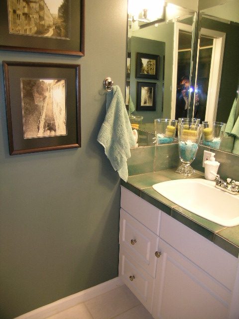 Bathroom with green walls, white cabinets, and framed artwork. - 2148 Kings Ave, West Vancouver