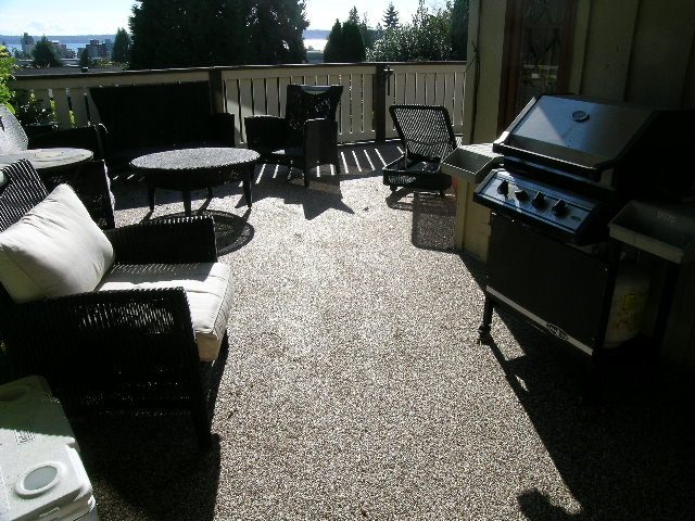 Bright patio with outdoor furniture, grill, and city view. - 2148 Kings Ave, West Vancouver