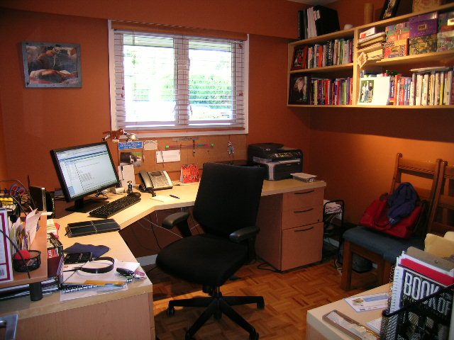 Home office with two desks, a black office chair, and a window with blinds. - 875 Whitchurch Street, North Vancouver