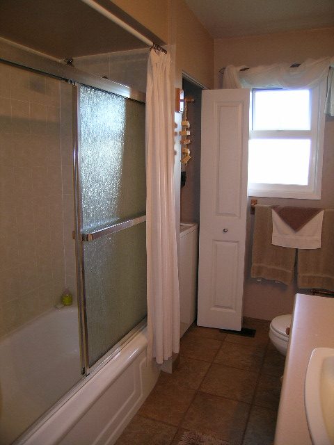 Bright bathroom with glass shower and tiled floor. - 875 Whitchurch Street, North Vancouver