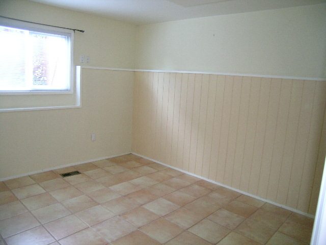Bright dining area with tiled floor and wainscoting wall. - 875 Whitchurch Street, North Vancouver