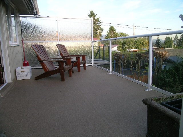 Deck with Adirondack chairs and a view of the garden. - 875 Whitchurch Street, North Vancouver