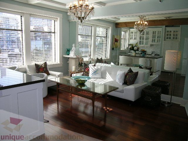Furnished living room with hardwood floors, large windows, and a chandelier. - 45 - 777 Burrard Street, Vancouver Downtown