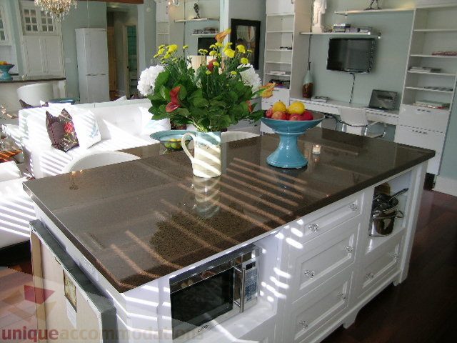 Bright kitchen with granite countertops, hardwood floors, and a vase of flowers. - 45 - 777 Burrard Street, Vancouver Downtown
