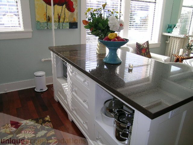 Bright kitchen with granite countertops, hardwood floors, and a vase of flowers on the counter. - 45 - 777 Burrard Street, Vancouver Downtown