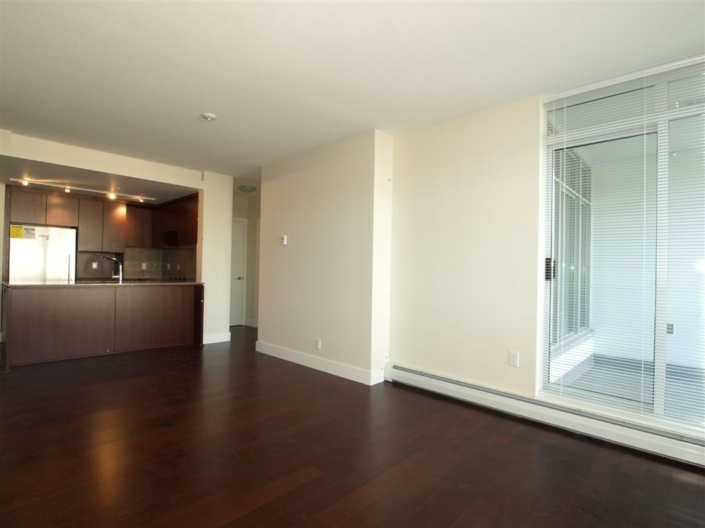 Open concept living space with hardwood floors and large windows. - 104 - 1320 Chesterfield, North Vancouver