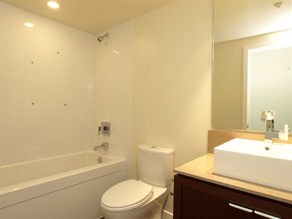 Bright bathroom with white fixtures and a modern sink. - 104 - 1320 Chesterfield, North Vancouver