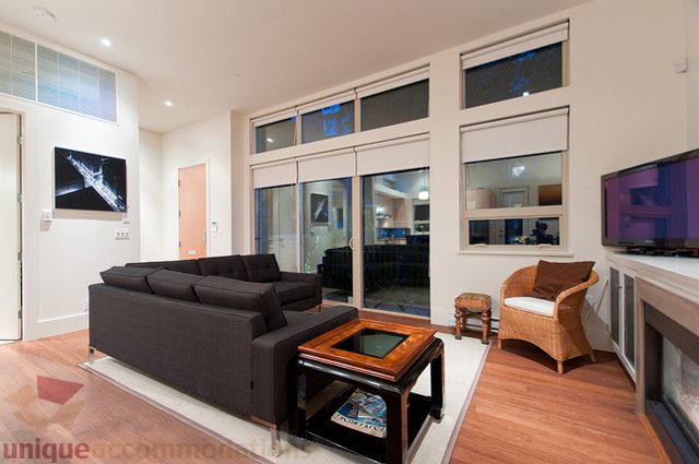 Furnished living room with hardwood floors, modern furniture, and city view. - 1381 Bute Street, Vancouver Downtown