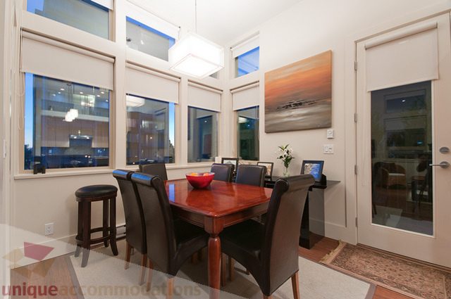 Dining area with large windows, modern decor, and city view. - 1381 Bute Street, Vancouver Downtown