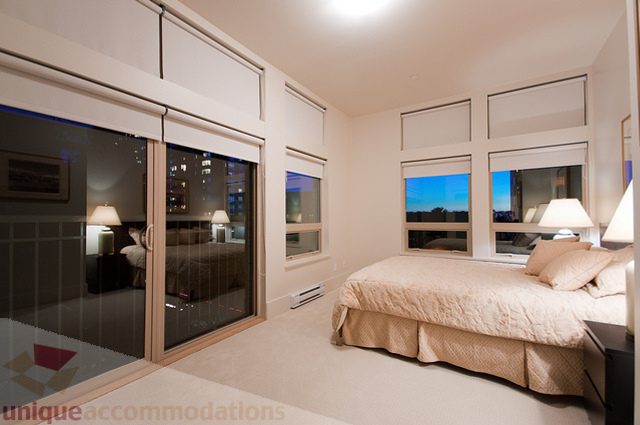 Furnished bedroom with large windows and city view. - 1381 Bute Street, Vancouver Downtown