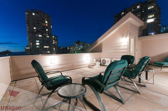 Furnished rooftop patio with lounge chairs and city views at dusk. - 1381 Bute Street, Vancouver Downtown