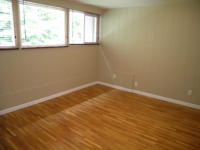 Spacious living room with hardwood floors and large windows. - 43 Glenmore Drive, West Vancouver