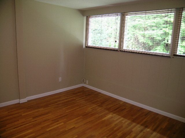 Spacious bedroom with hardwood floors and large windows. - 43 Glenmore Drive, West Vancouver