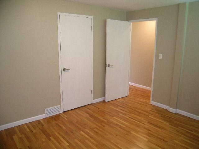 Spacious living room with hardwood floors and open door leading to another room. - 43 Glenmore Drive, West Vancouver