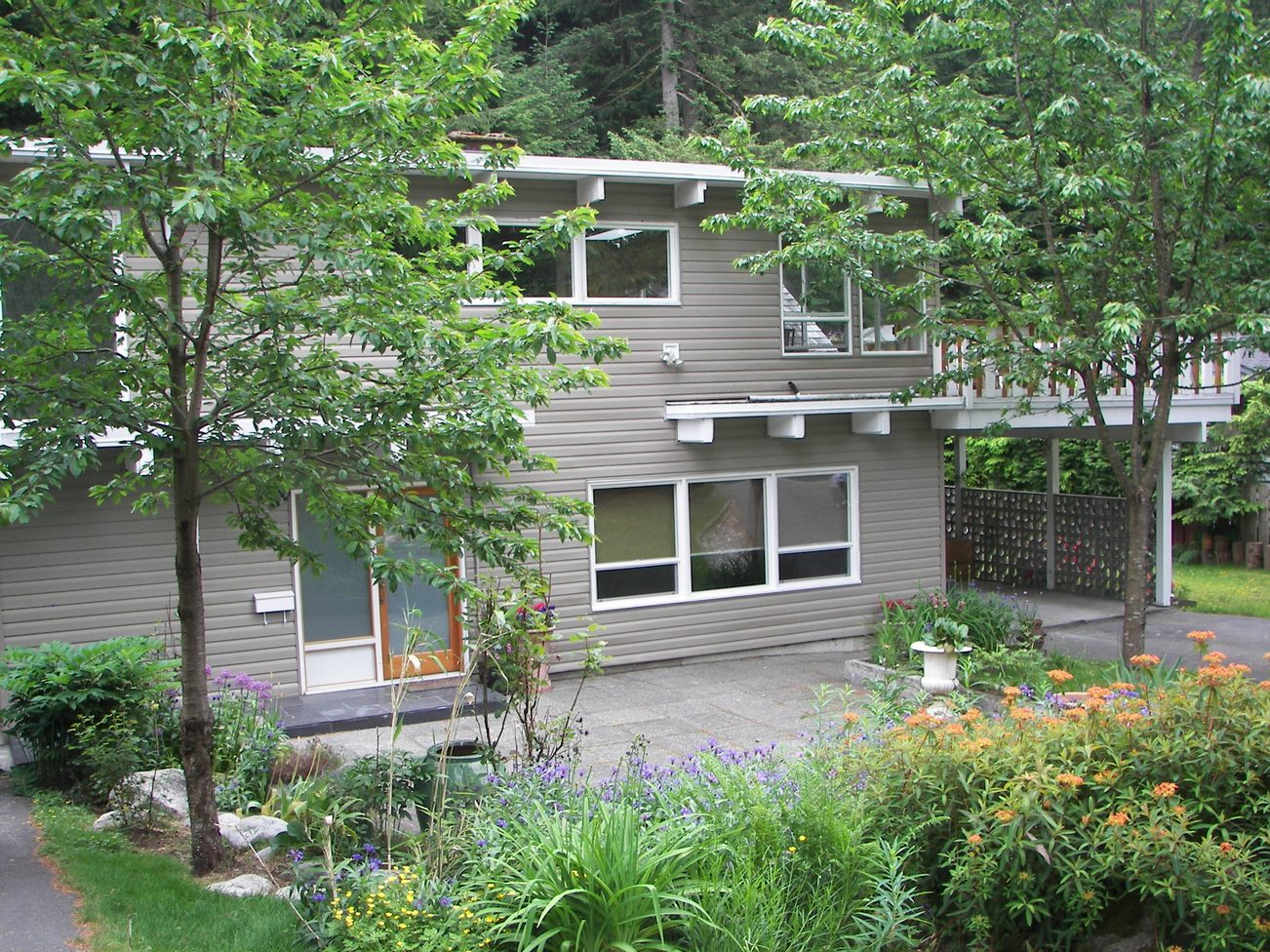 Spacious 3-bedroom house with modern design, large windows, and lush garden. - 43 Glenmore Drive, West Vancouver
