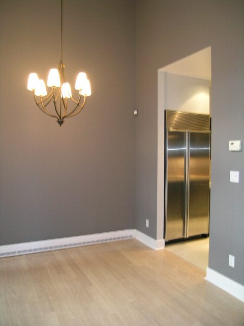 Modern kitchen with stainless steel appliances and hardwood floors. - 1455 West Hastings, Vancouver Downtown