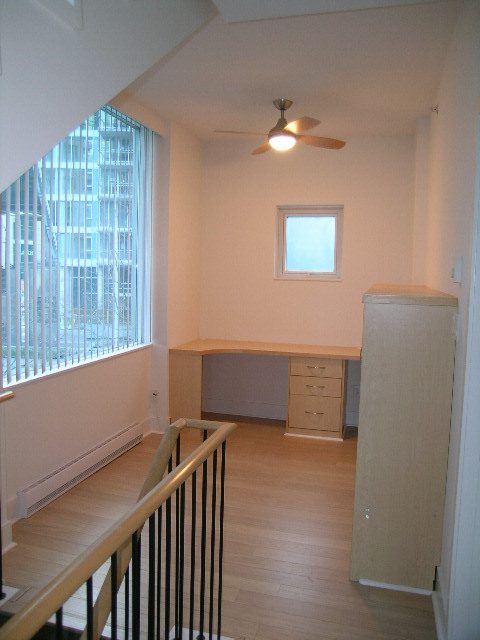 Open-plan living area with hardwood floors, city view, and modern furnishings. - 1455 West Hastings, Vancouver Downtown