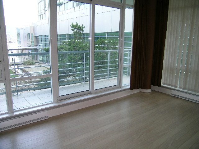 Spacious living room with hardwood floors, large windows, and a city view. - 1455 West Hastings, Vancouver Downtown